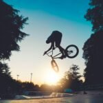 man riding on bicycle on road during daytime